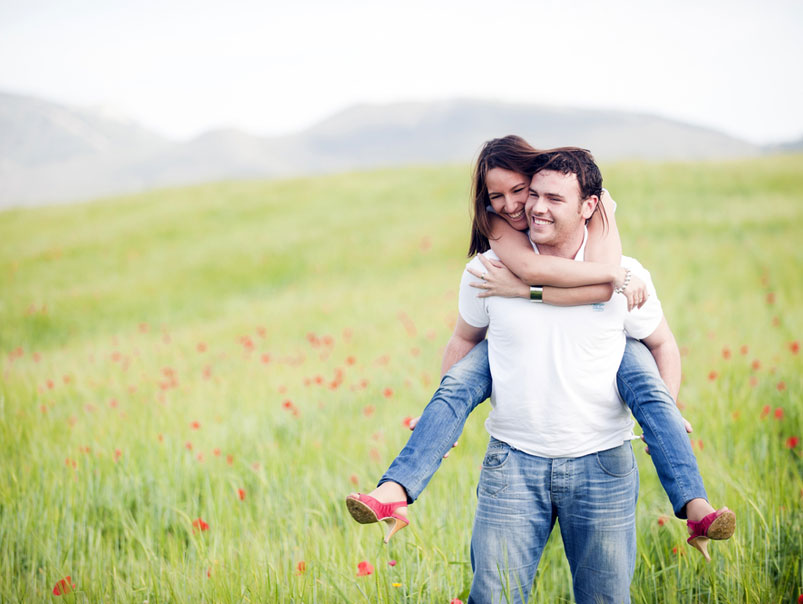 Couple Doing Piggy Back In Field